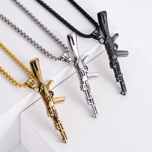Detailed view of AK47 rifle necklaces in gold, silver, and black polished steel