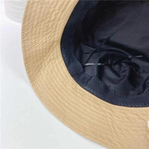 Detail of khaki bucket hat showing black inner lining and adjustable drawstring