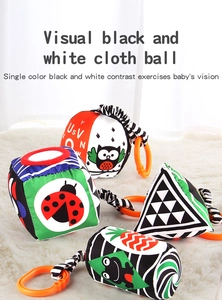 Macro view of four geometric soft cloth baby toys with high-contrast patterns and orange rings