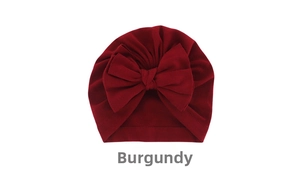 Detail view of wine red baby turban hat with decorative oversized knot bow detail