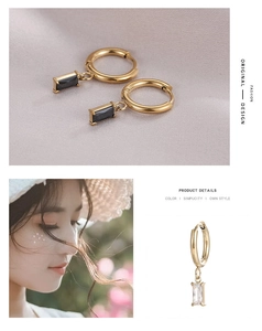Detail of elegant gold hoop earrings with rectangular black and clear crystal pendants