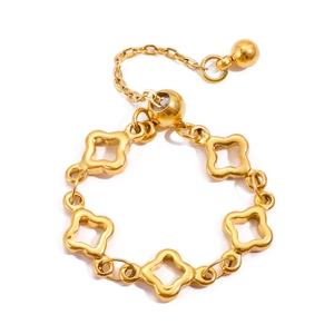 Close-up of golden adjustable chain ring featuring hollow floral link charms and slide bead