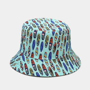 Close-up of mint green cotton bucket hat with colorful surfboard and ocean calling print