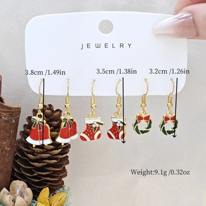 Detail of Christmas earring set showing bell, stocking, and wreath designs with size info