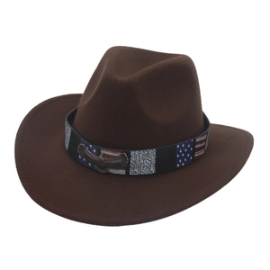 Close-up of brown felt cowboy hat featuring star-striped band and metallic eagle logo