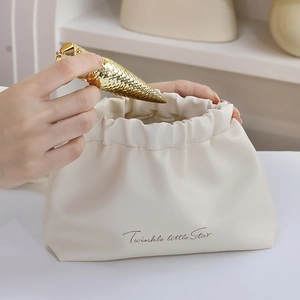 Beige PU leather drawstring cosmetic bag with Twinkle Little Star gold text and lipstick