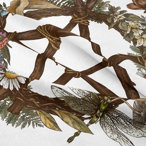 Detail of bohemian tapestry fabric showing botanical dragonfly and pentagram print