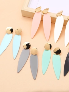 Group display of gold plated teardrop earrings in various macaron colors on a tray