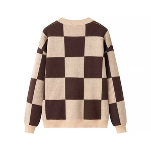 Detail shot of the knit texture and brown checkerboard pattern on the casual sweater