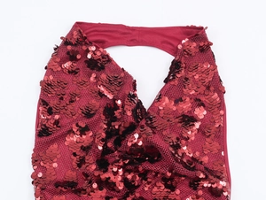 Detailed close-up of shiny red sequins on halter neck mesh fabric dress for parties