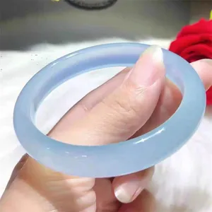 Detailed close-up of translucent sky blue agate chalcedony bangle with a smooth polished finish