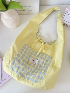 Light yellow canvas tote bag with blue plaid pocket and ribbon tie closure for women