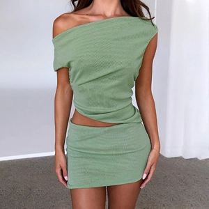 Chic grass green ribbed knit two-piece set with off-shoulder top and mini skirt