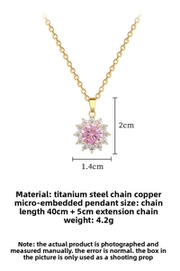 Detail of titanium steel necklace with a sun-shaped pink gemstone pendant and micro-pave crystals
