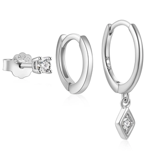 Detail of 925 sterling silver earring set with minimalist polished hoops and zircon stones