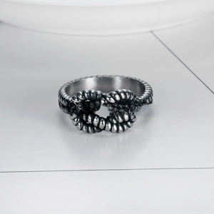 Detailed close-up of retro stainless steel ring with double braided knot texture