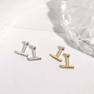 Detailed view of 925 sterling silver rectangular stud earrings in gold and silver finish