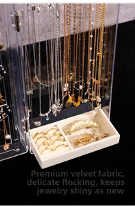 Macro detail of acrylic jewelry box with necklace hooks and velvet ring slots