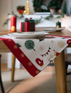 Detail of Christmas table runner with festive prints and textured fabric drape