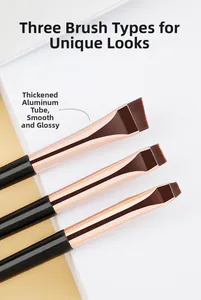 Detail of three professional flat eyeliner and eyebrow brushes with rose gold ferrules