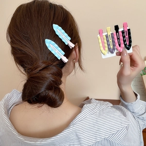 Close-up of matte pastel wave-textured hair clips in a stylish side-hair arrangement