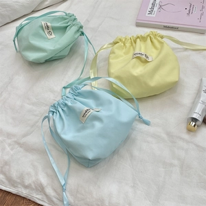 Pastel drawstring storage pouches in mint green and light blue for jewelry and makeup