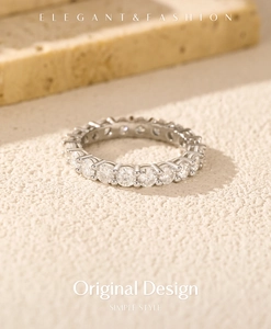 Macro detail of VVS1 moissanite stones set in a sterling silver eternity band