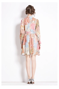 Rear view of vintage patchwork floral dress featuring long sleeves and a matching belt