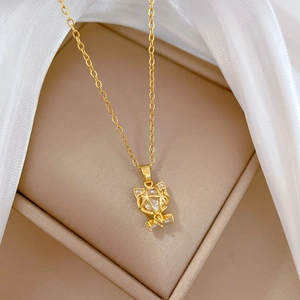 Macro shot of gold cat pendant with large crystal and sparkling pavé details