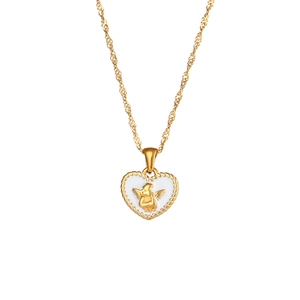 Vintage gold heart pendant necklace featuring an angel relief on a white background