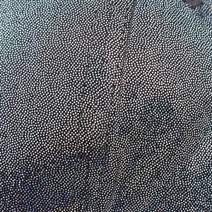 Macro detail showing shimmering silver glitter and sequins on a black PU fabric texture