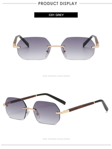 Detail view of rimless hexagonal sunglasses with grey gradient lens and wood grain temples