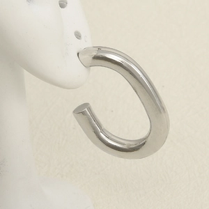 Detailed view of thick silver C-shaped hoop earrings on a professional ear model display