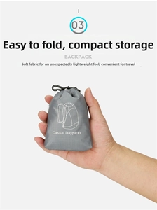 Close-up of compact foldable grey backpack stored in a small pouch with a hanging hook