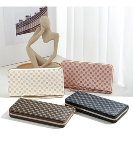 Collection of zip-around purses with geometric prints in yellow, pink, brown, and black