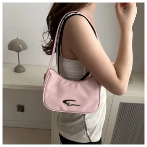 Close-up of pink crescent underarm bag with silver metallic trim worn by a model