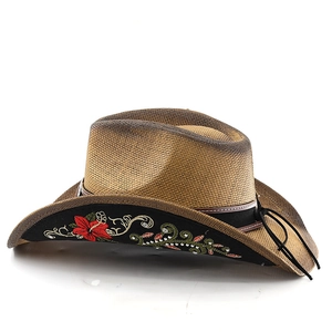 Close-up of floral embroidery and white rhinestones on the inner brim of the straw cowboy hat
