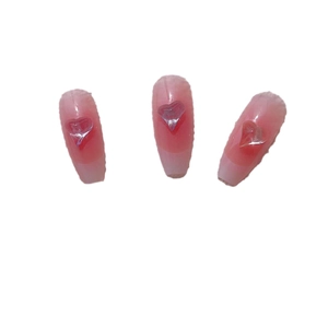 Pink gradient coffin fake nails with 3D crystal heart charms on white background