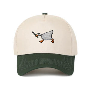 Detail of goose with knife embroidery on a two-tone cream and green baseball cap