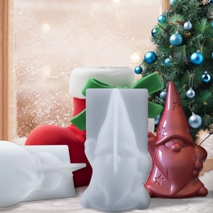 Detail of gnome silicone mold next to a red resin Christmas ornament in festive scene