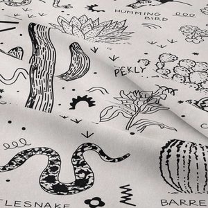 Macro detail of desert wildlife line art print on textured cotton fabric weave