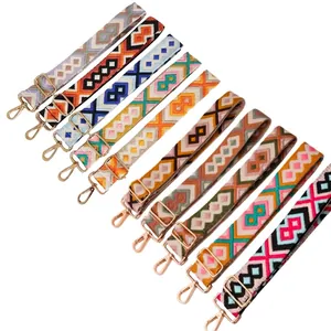 Selection of 3.8cm ethnic woven guitar bag straps with gold metal clasps and hardware