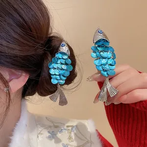 Creative silver fish hair clips featuring layered blue shell sequins for women
