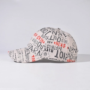 Graffiti style baseball cap in beige with black and red street art print for unisex wear