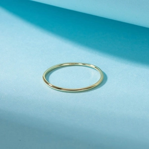 Macro detail of S925 sterling silver stamp on minimalist gold thin ring band