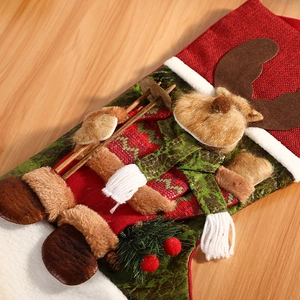 Festive Christmas stocking featuring a plush 3D reindeer with wooden skis on wood backdrop