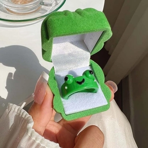 Close-up of a cute green frog open ring with a matching velvet frog jewelry box