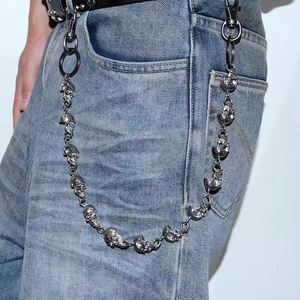 Detail of silver skull jean chain showing the punk gothic style on denim pants