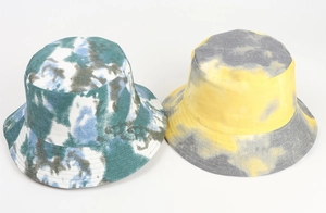 Detailed view of two tie-dye bucket hats in green-blue and yellow-grey cotton fabric