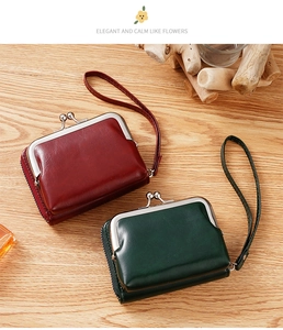 Detail of vintage kiss-lock coin purses in burgundy and dark green with wrist straps